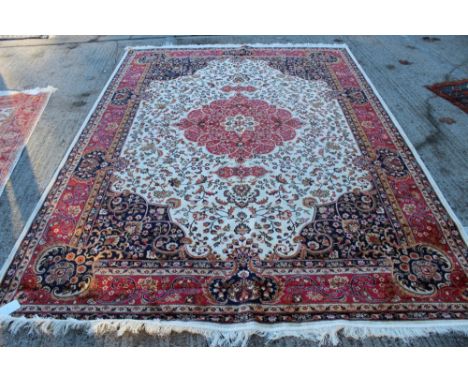 Modern Kashan carpet with scrolling foliage on beige ground in wavy spandrels and multiple borders, 280cm x 200cm