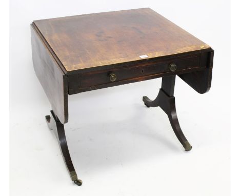 Regency mahogany and rosewood crossbanded sofa table, the rounded rectangular drop-leaf top over frieze drawers and opposing 