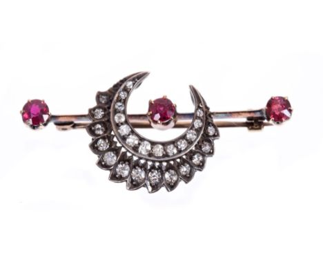 Late Victorian ruby and diamond brooch with a crescent of old cut diamonds on a bar with three mixed cut rubies, 42mm