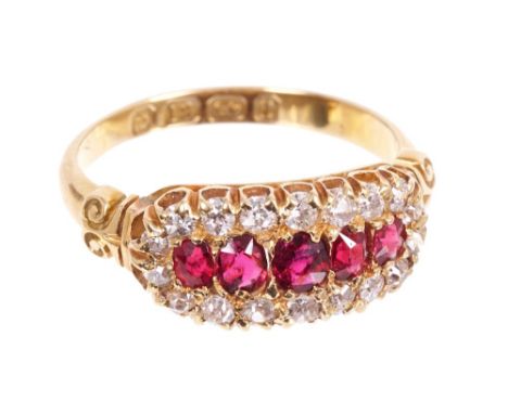 Late Victorian ruby and diamond ring with five graduated oval mixed cut rubies surrounded by a border of old cut diamonds in 