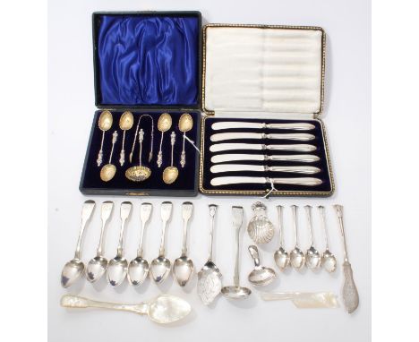 Late Victorian cased set of six silver apostle spoons, matching sugar tongs and sifter spoon, a cased set of six tea knives w