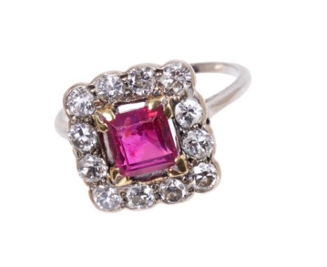 Ruby and diamond cluster ring with a rectangular step cut ruby measuring approximately 5.9 x 5.5 x 3.5mm, surrounded by a bor