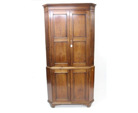 Good George III fruitwood crossbanded standing corner cupboard, the upper section with concave cornice and line-inlaid tablet