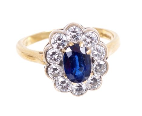 Sapphire and diamond cluster ring, the oval mixed cut blue sapphire measuring approximately 7.30 x 5.07 x 3.14mm, in claw set