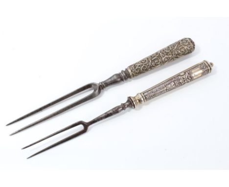 Two 18th century German two-pronged forks, the first with filigree foliate handle, 22cm long, the other with Baroque mask and
