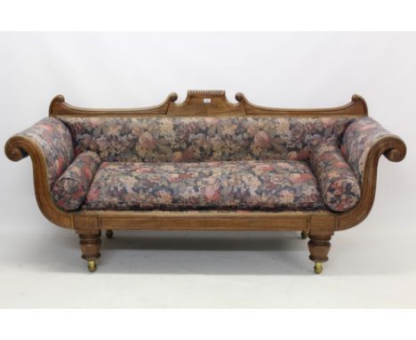 Regency mahogany scroll-end sofa with undulating show-wood back and tablet frieze, on bulbous legs and castors 