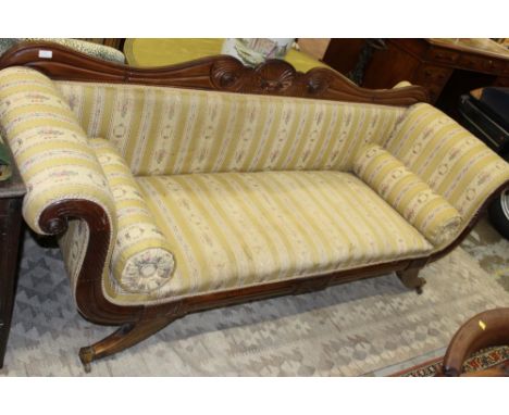 Regency mahogany scroll end sofa with undulating show-wood back and shaped satin upholstery on splayed legs and castors