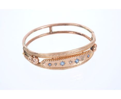 Edwardian 9ct rose gold hinged bangle with pale blue sapphires and rose-cut diamonds on star-shape setting (Chester 1906) CON
