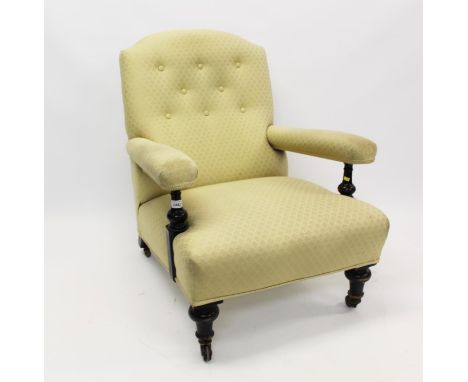 Victorian ebonised deep armchair with button-back lemon silk upholstery, on turned legs and castors CONDITION REPORT structur