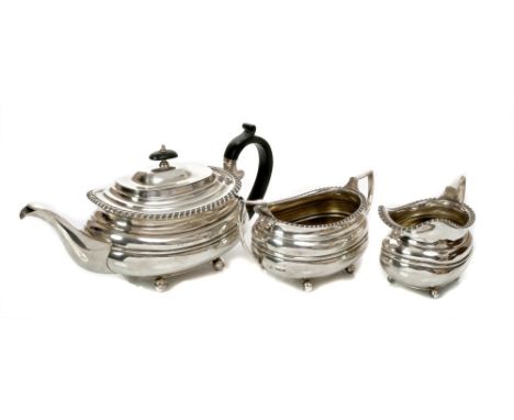 1930s silver three piece tea set - comprising large teapot of compressed baluster form, with gadrooned border, ebony loop han