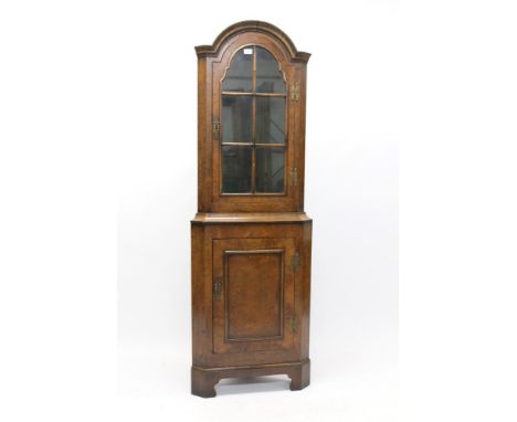 Good quality Queen Anne-style framed walnut standing corner cupboard with arched glazed section and panel cupboard below, on 