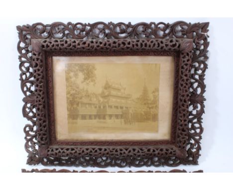 Pair of late 19th century Burmese glazed photographs, the first showing a temple complex, the other a seated group of dignita