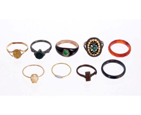 An interesting group of nine antique rings - to include an antique black enamel ring with green cabochon stone and a blued st