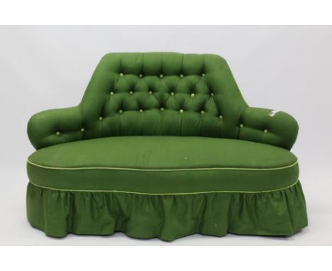 Victorian button-back corner settee with arched back, on cabriole legs and castors, leaf-green upholstery