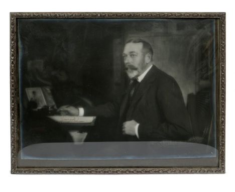 HM King George V - signed Royal Presentation silver bromide portrait photograph of The King seated at his desk, signed in ink