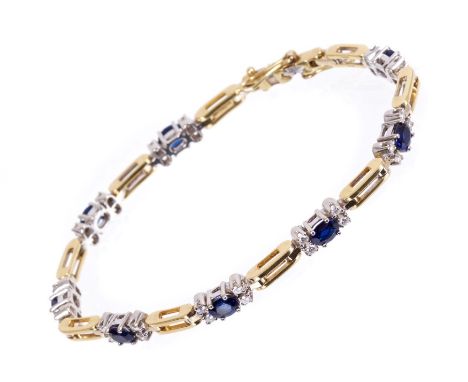 Sapphire and diamond bracelet with eight clusters, each with an oval mixed cut blue sapphire flanked by four brilliant cut di