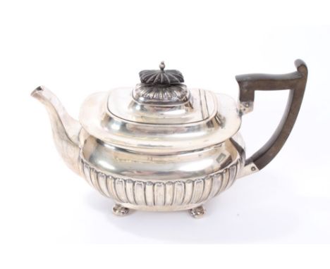 Late Victorian silver teapot of compressed baluster form, with half-fluted decoration and flared rim, angular ebony handle an