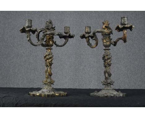 A pair of late 19th century gilt metal (worn) Gothic style candelabras. Decorated with serpents on the trunk and a floral lea