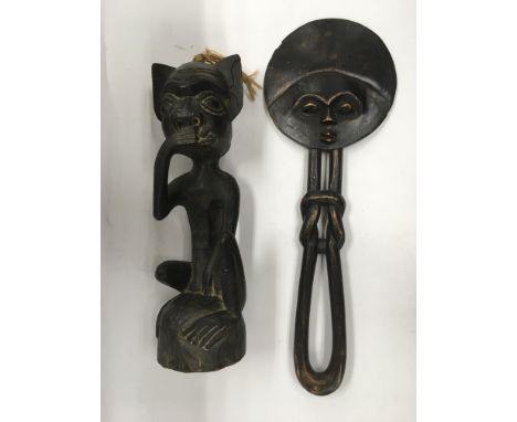 Two items of tribal art comprising a carved wooden figure of a seated demon like creature, approx 40cm, together with an orna