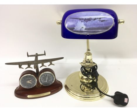A desk lamp decorated with WW2 planes and a desk clock of similar type