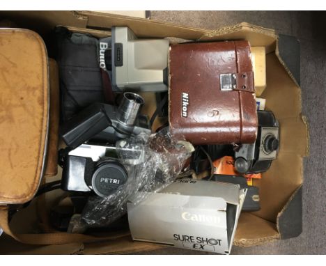 A box containing vintage camera equipment including a vintage Petri 7 S. Neon binoculars and others