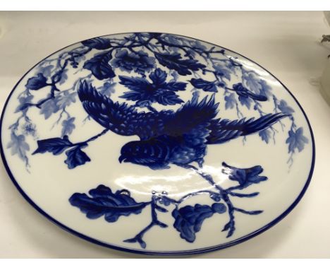 A 19th century Worcester porcelain blue and white wall plaque decorated with a bird amongst foliage impressed marks to the re
