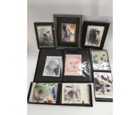 A collection of various sketch books including various surrealistic images in different mediums.