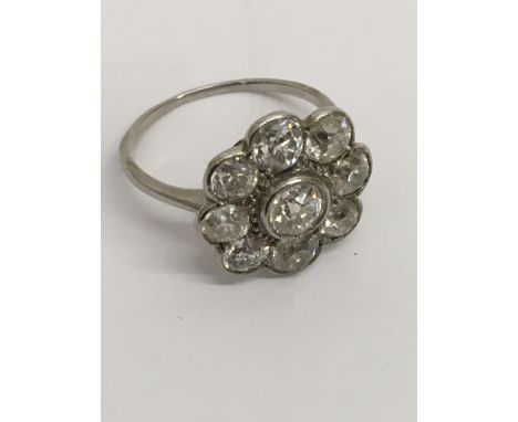 A 1920's white gold diamond cluster ring, set with old cut diamonds,unmarked.Approx size R.