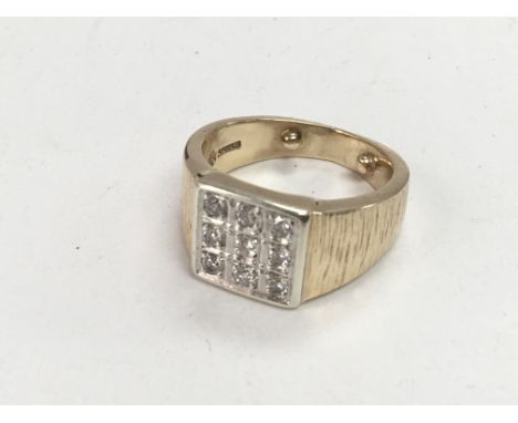 A Gents 9cart gold ring pave set with diamonds.ring size Q-R weight 12.5g
