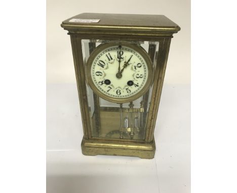 A four glass mantle clock the dial with Arabic numerals and visible mercury pendulum