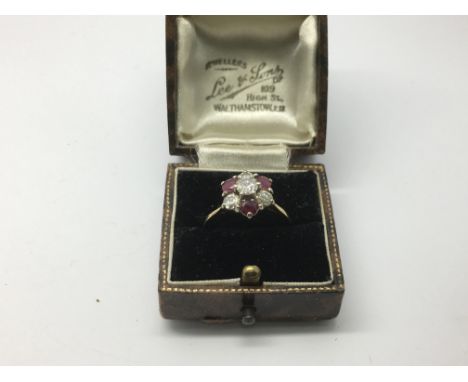 An 18ct gold diamond and ruby cluster ring, approx 3.6g and approx size N-O.