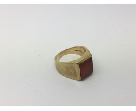 A 9ct gold Gents ring set with a polished stone, approx 12.3g and approx size R-S.