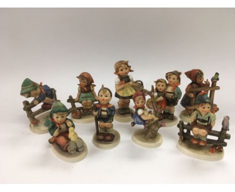 Nine Goebel Hummel figures of children.