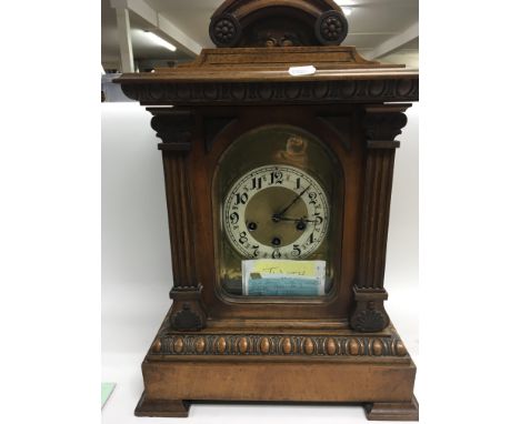A Continental late 19th Century walnut mantel or bracket clock striking on gongs.