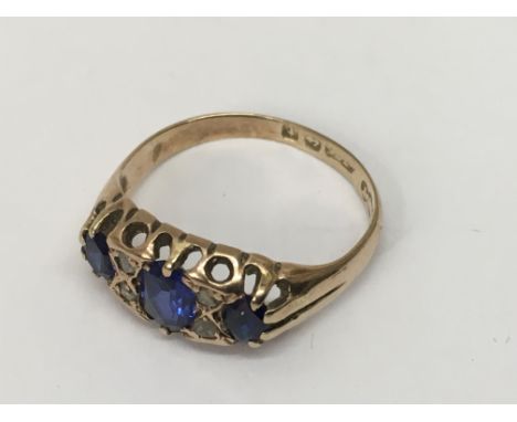 A 9ct gold ring set with three sapphires.Approx size K