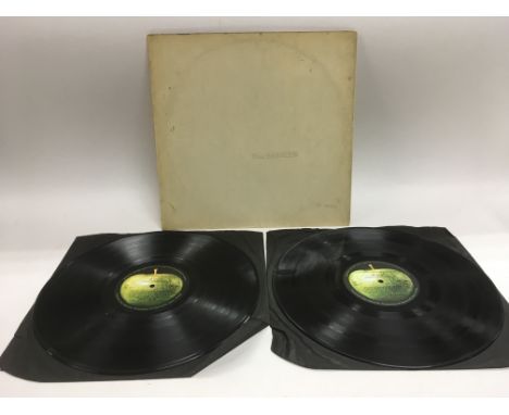 A numbered Beatles 'White Album', no. 0061279. No poster or portraits, vinyl scratched. Top loading with black inners present