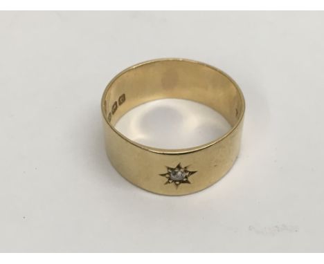 An 18ct gold ring set with a single diamond, approx 6g and approx size R.