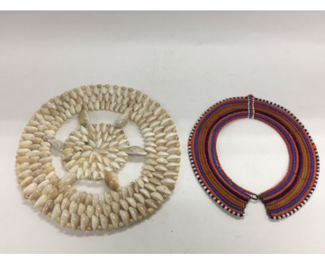 An African beadwork necklace and a cowrie shell item (2).