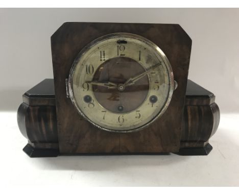 A wood cased Art Deco mantle clock with keys.