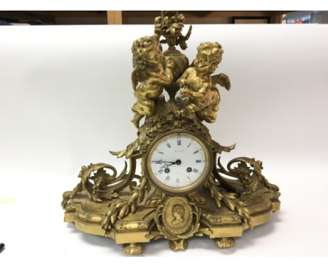 A Quality French Ormolu mid 19th century clock the case surmounted with winged cherubs and with folate scrolls maker Bourdin 