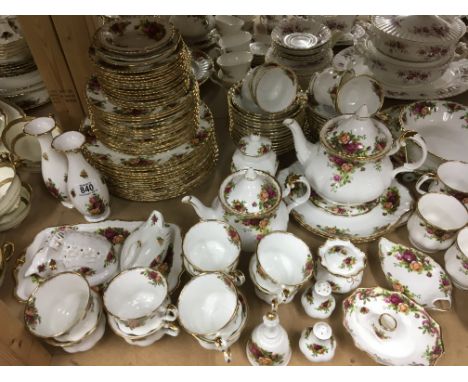 A Collection of royal Albert country rose including cups saucers tea pot milk jug sugar bowl and vases