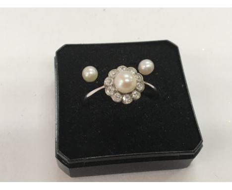 An 18carat gold ring set with culture pearls and small diamonds with conforming earnings in a fitted box ring size R.