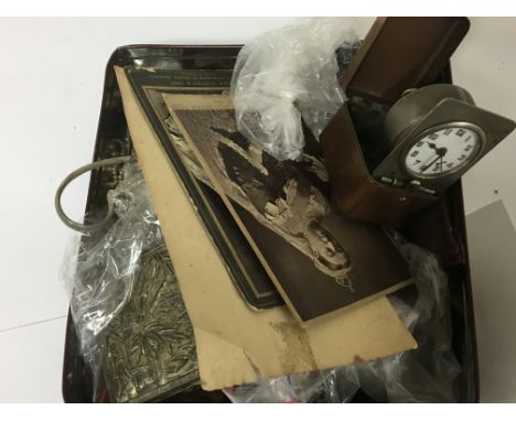 A tin containing oddments various. Including a copper cased travelling clock - NO RESERVE