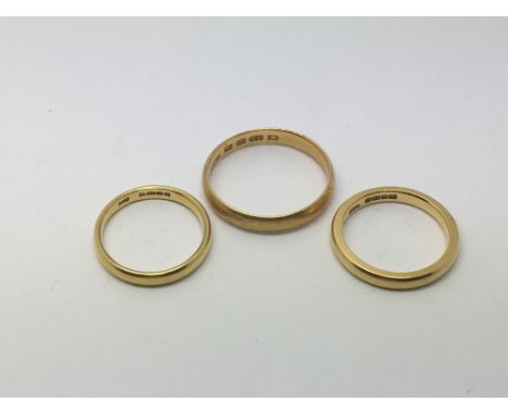 Three 22ct gold wedding bands, approx total weight 11.7g. Sizes approx U, L-M and K.