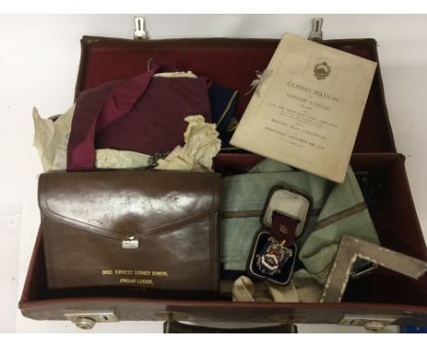 A case containing Masonic regalia. Including a silver and enamel Jewel