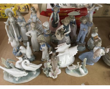 A collection of figures including lladro Doulton and nao