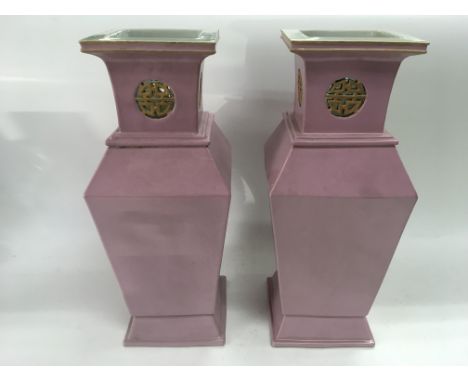 A pair of pink ceramic vases of squared form with Oriental style decoration, approx 35.5cm.