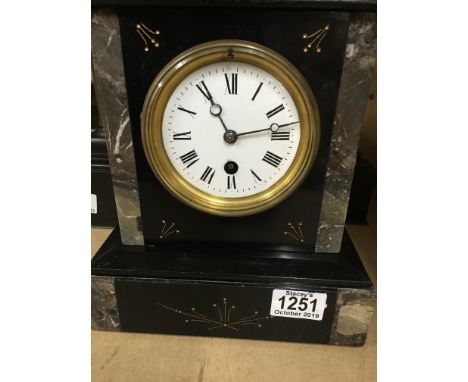A slate mantle clock with Arabic numerals and a smaller slate mantle clock with Roman numerals