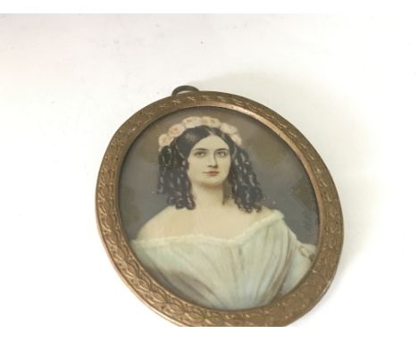 An Early 19th Century oval portrait miniature depicting a young girl with flowers in her hair unsigned and unattributed.7cm i