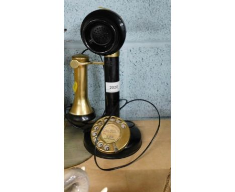 A brass and metal candlestick telephone, with paper label for GEC Made in England.